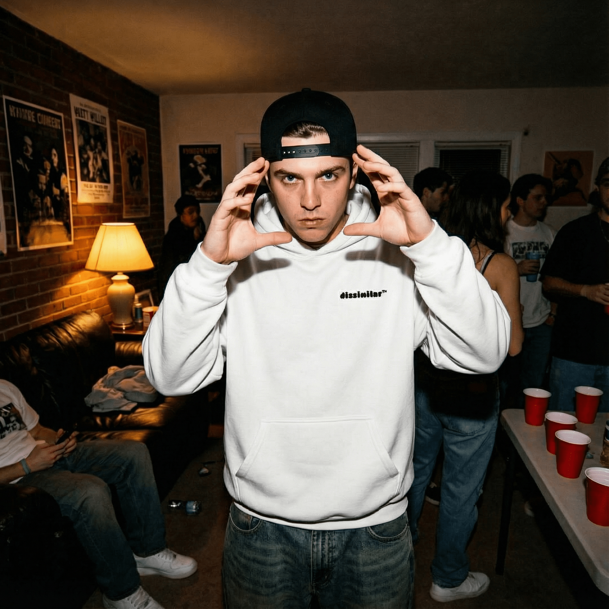 Young_man_direct_camera_gaze_intense_expression_streetwear_fashion_wearing_oversized_duck_white_front_black_snapback_cap_hand_gestures_framing_face_indoor_setting_dim_ambient_lighting.png